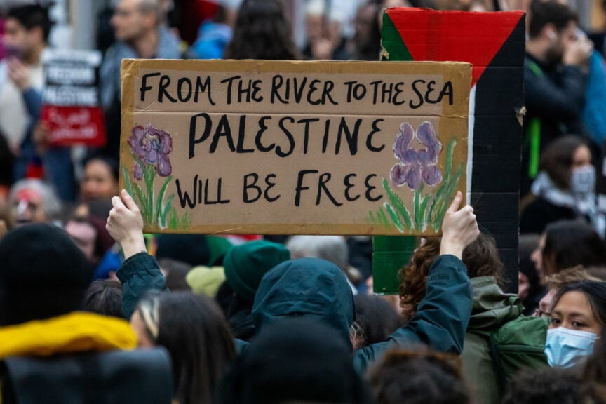 A pro-Palestinian activist holds up a sign reading 'From The River To The Sea Palestine Will Be Free' during a sit-down protest inside Charing Cross railway station to call for an immediate ceasefire in Gaza on 4th November 2023 in London, United Kingdom. Mass Palestinian solidarity rallies have been held throughout the UK for a fourth consecutive weekend to call for an end to the Israeli bombardment of Gaza. (photo by Mark Kerrison/In Pictures via Getty Images)