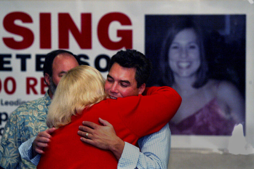 Scott Peterson gets a hug from his sister in law Alison Peterson from San Diego who arrived to help distribute posters. Laci's photo is on poster in background.Scott Peterson from Modesto California, husband of missing Laci Peterson who was due with their first child on February10 passed out flyers at the Doubletree Hotel in Westwood to volunteers willing to put them up in their communities. Peterson was joined by his parents and several other family members to help him. (Photo by Anne Cusack/Los Angeles Times via Getty Images)