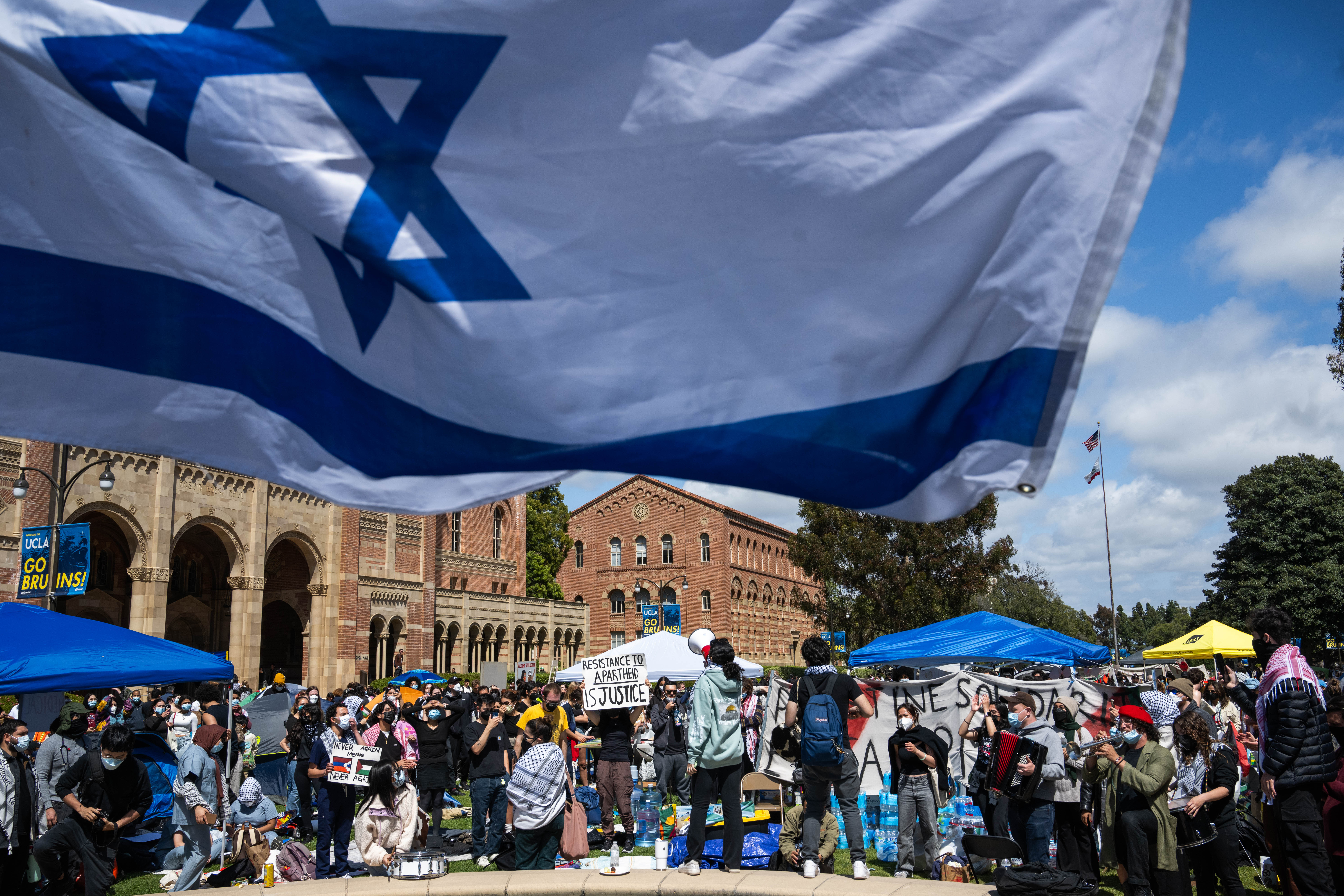 UCLA Jewish students waving Israeli flags counter-protest fellow students in their Palestinian solidarity camp on their Westwood campus on Thursday, April 25, 2024. College protests around the country are seeking their schools divestment in Israel over the Israel-Hamas war.
