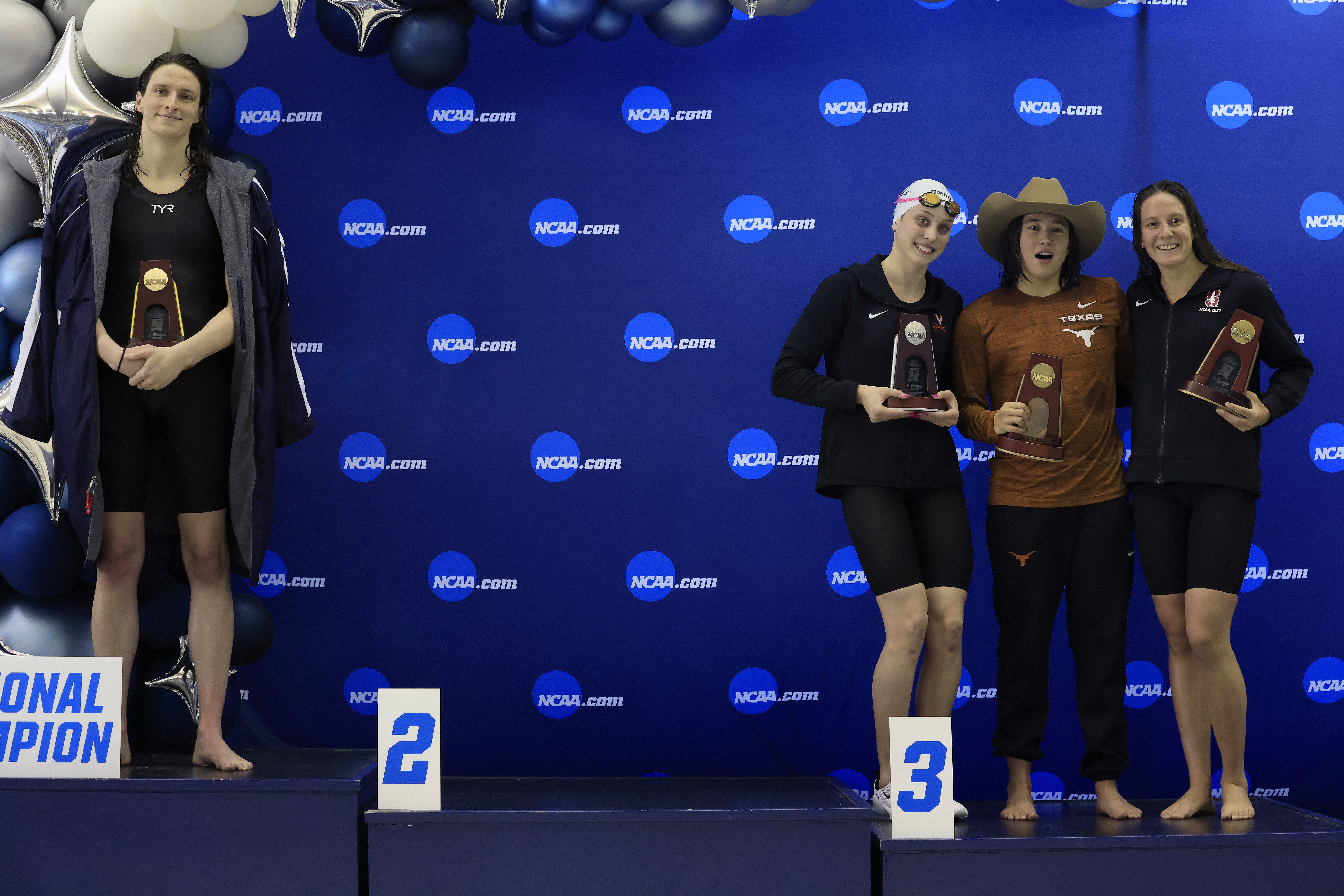 Transgender woman Lia Thomas (L) of the University of Pennsylvania stands on the podium after winning the 500-yard freestyle as other medalists (L-R) Emma Weyant, Erica Sullivan and Brooke Forde pose for a photo at the NCAA Division I Women's Swimming & Diving Championshipon March 17, 2022 in Atlanta, Georgia.